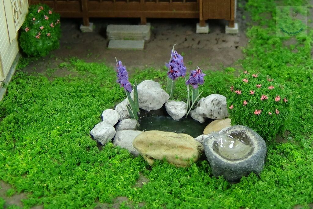 Decorative pond with a little stone basin fountain
