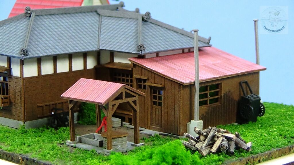 The pile of firewood at the back behind the bath-house